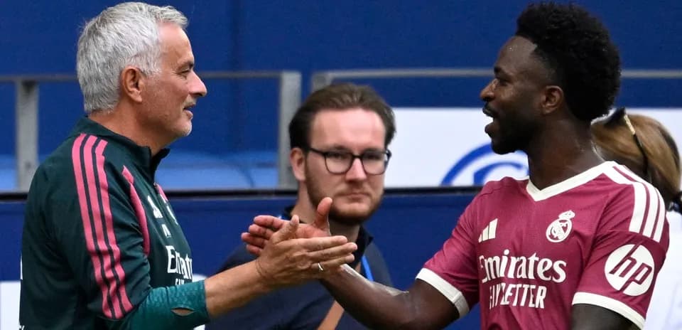 Trainers shaking hands during a match warm-up