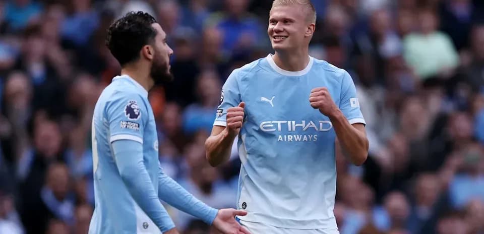 Manchester City players celebrating a goal on field
