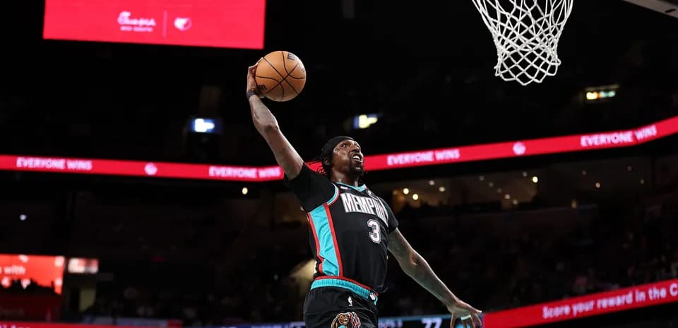 Player dunking during basketball game at arena