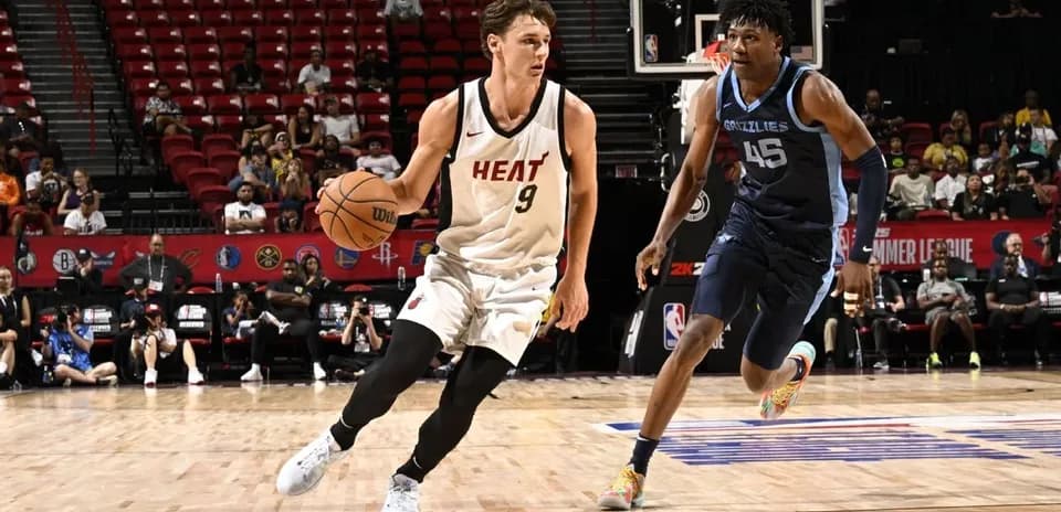 Player from Miami Heat dribbling past opponent