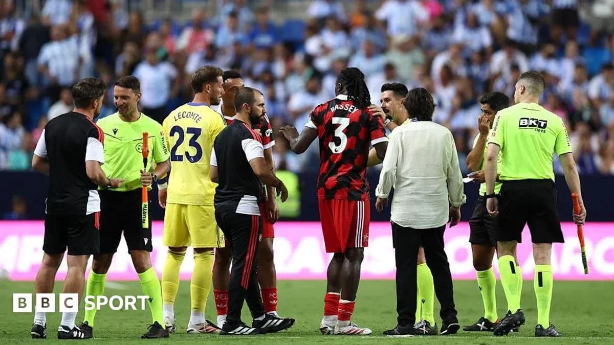 Players and officials discussing on the pitch