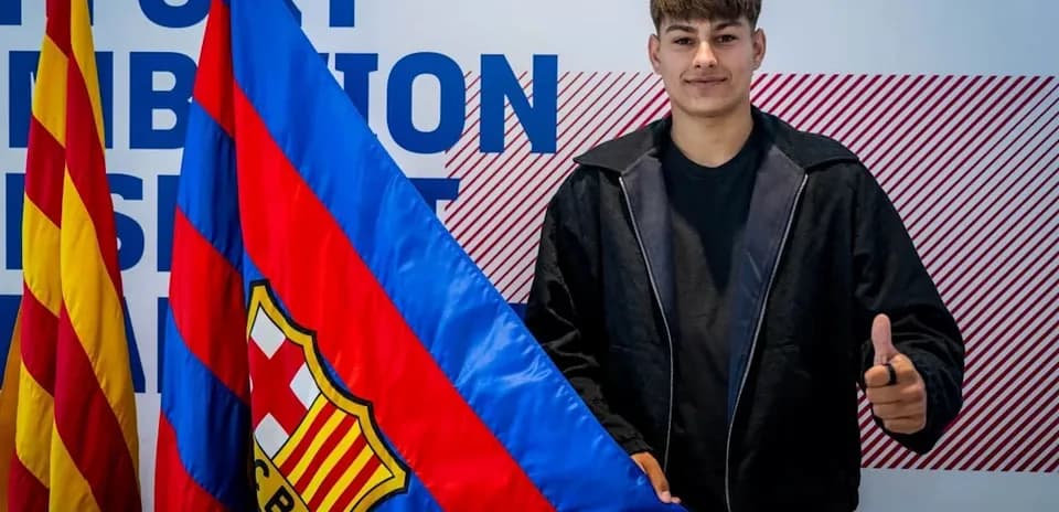 Young player holding FC Barcelona flag and posing
