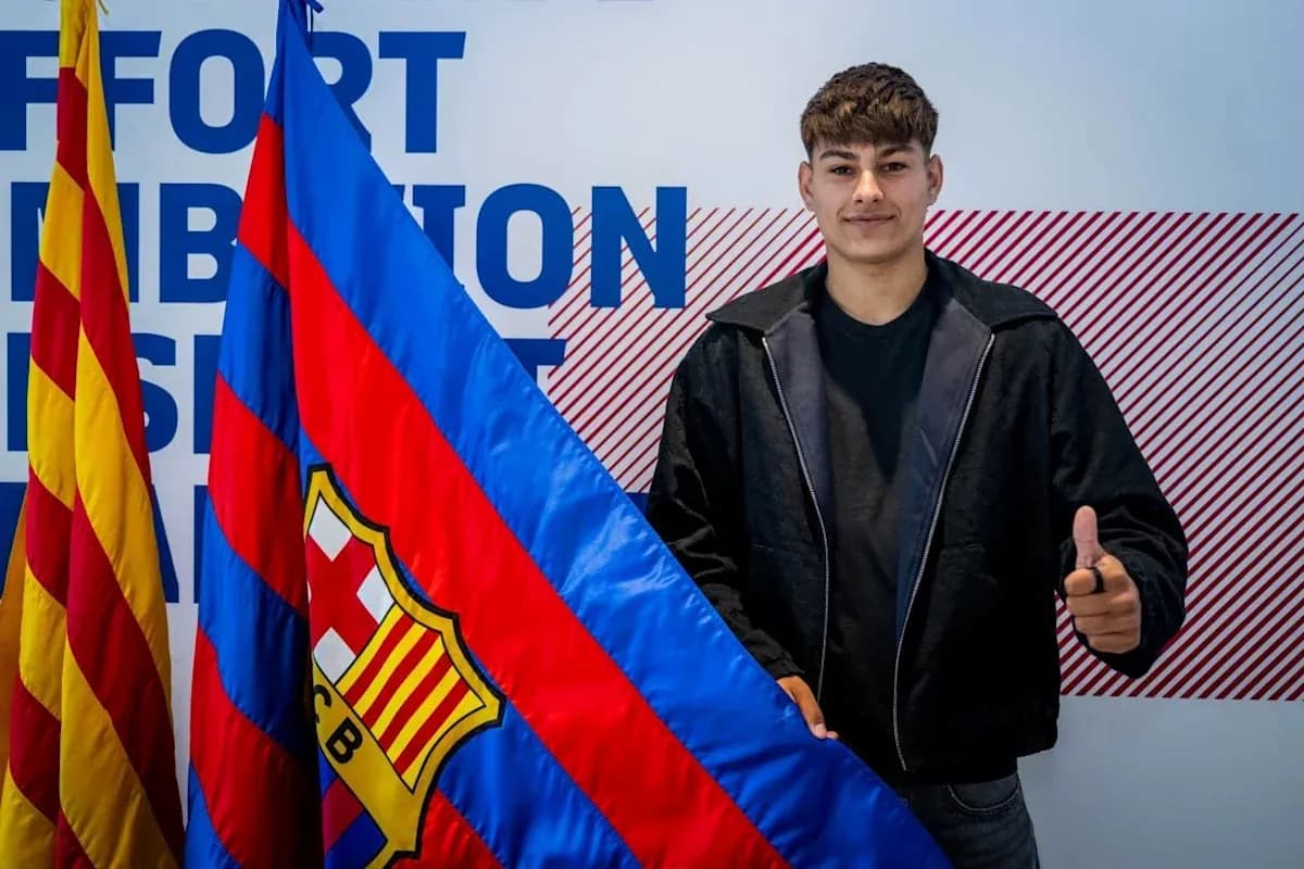 Young player holding FC Barcelona flag and posing