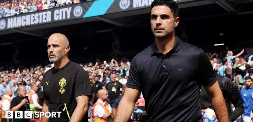 Two managers walking onto the pitch before match