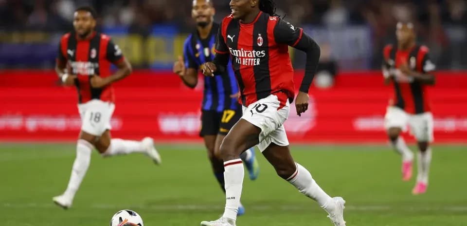 Milan player dribbling ball during match against opponent