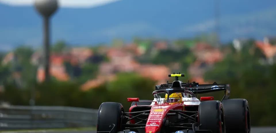 Formula 1 car racing on track with city background