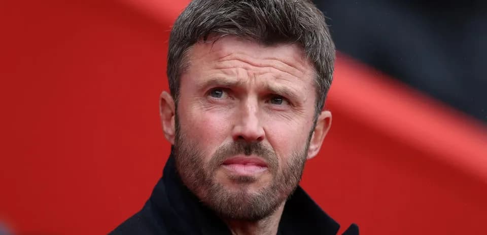 Men's football coach observing match from sidelines