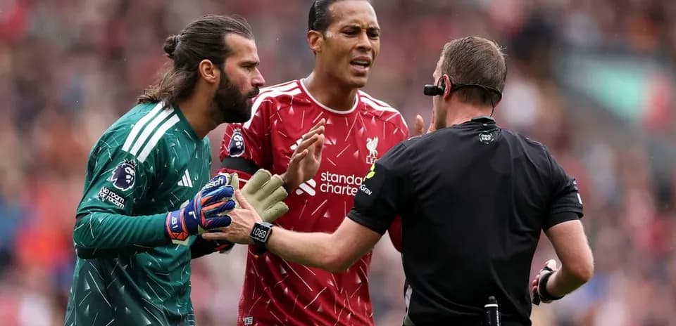 Alisson and Van Dijk arguing with referee