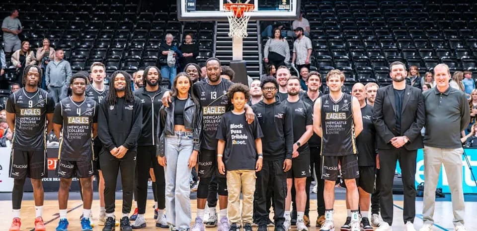 Newcastle Eagles team posing on basketball court