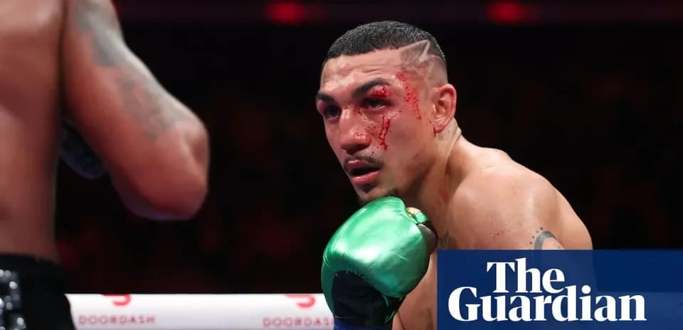 Boxer with blood on face during match