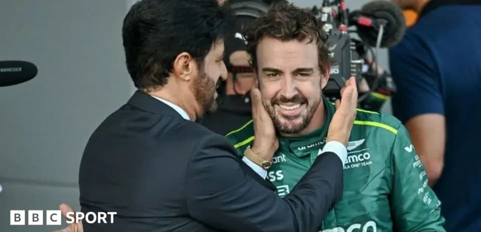 Fernando Alonso celebrating with team representative after race