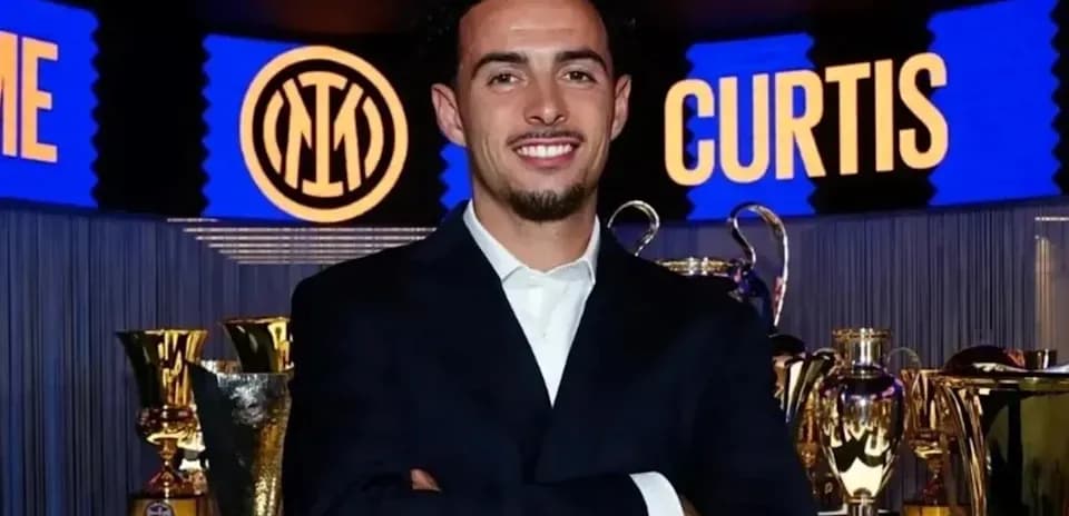 Young man posing with trophies at event
