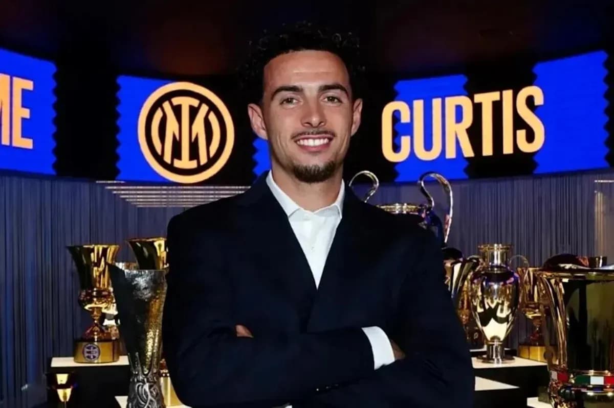 Young man posing with trophies at event