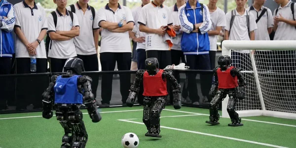 Robot soccer match with students watching