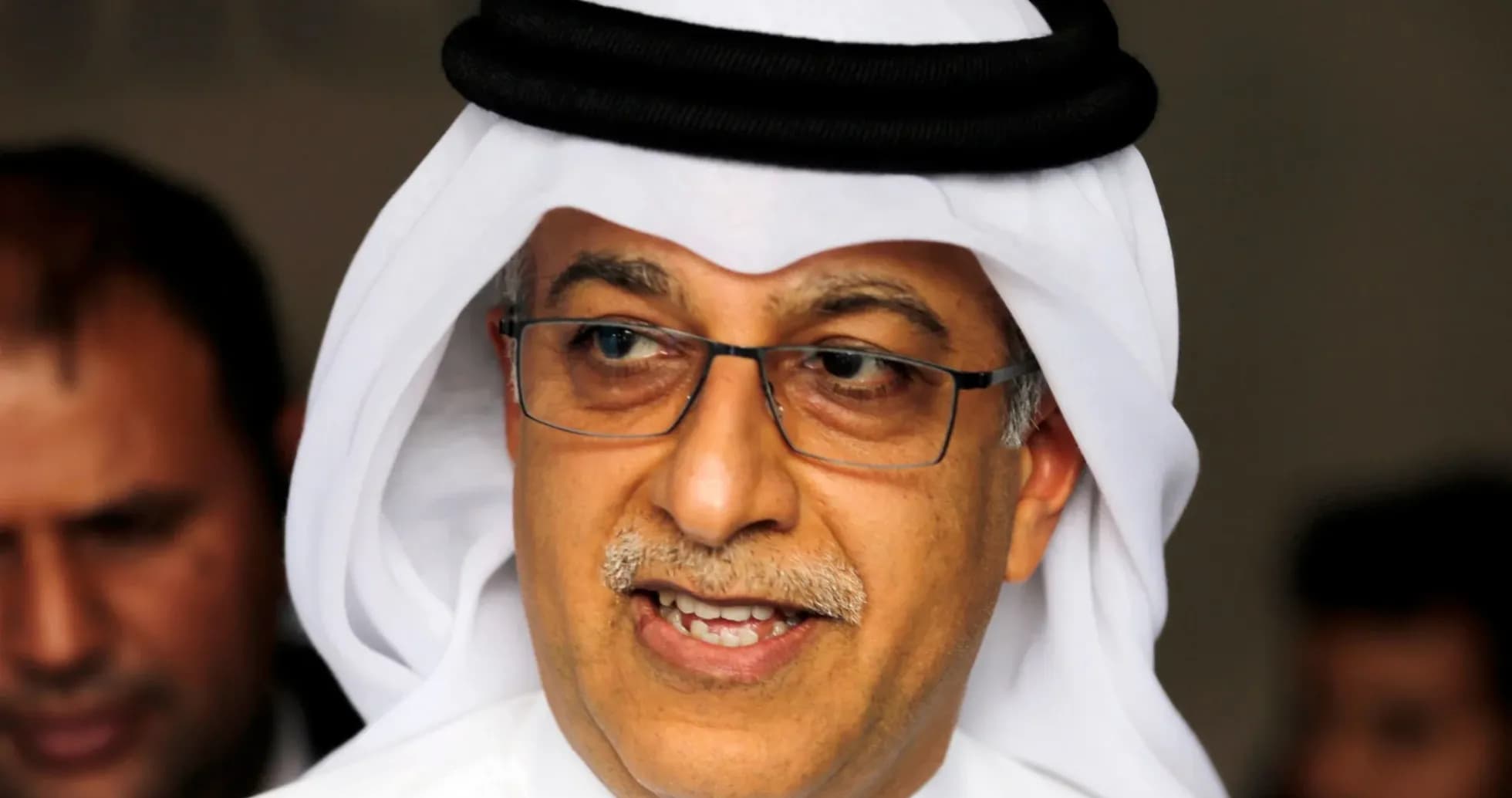 Shirted man wearing traditional headwear speaking