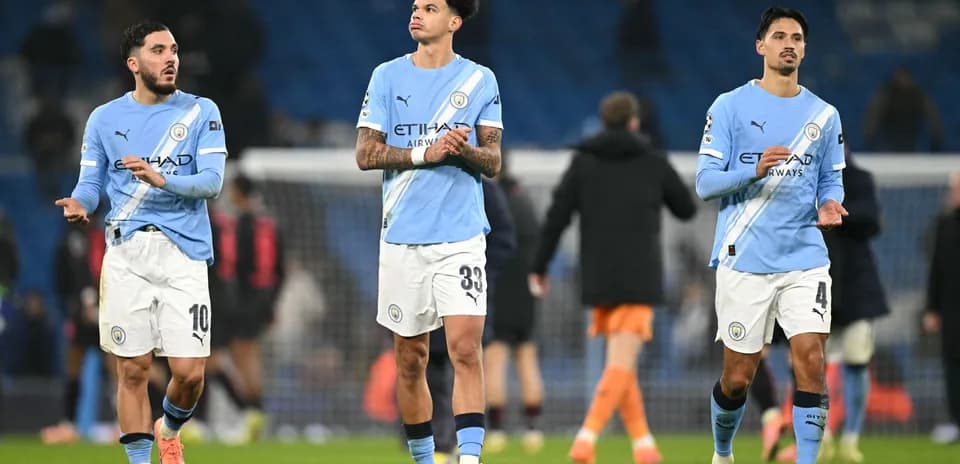 Manchester City players walking off the pitch