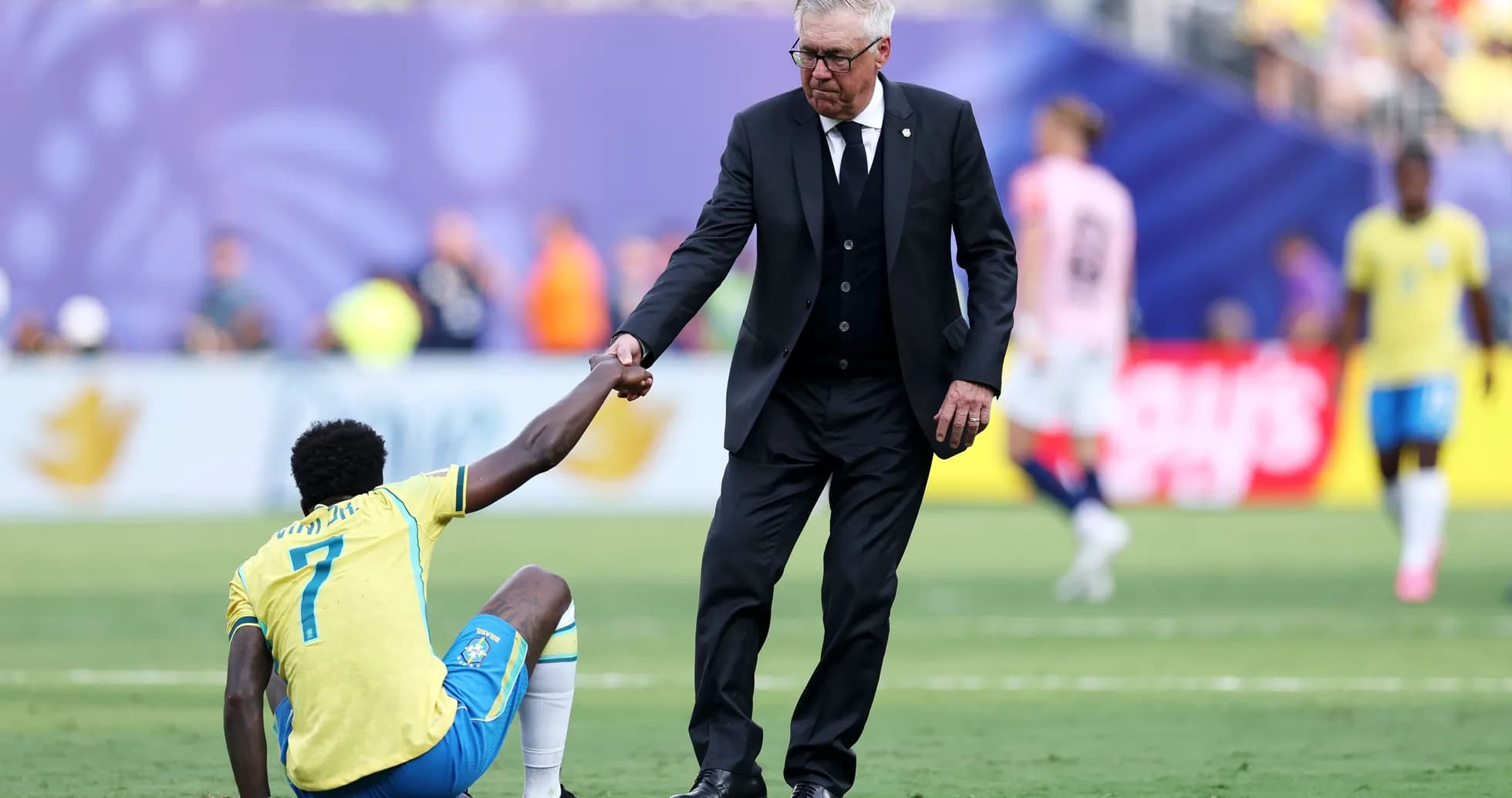 Coach helping player up from the ground
