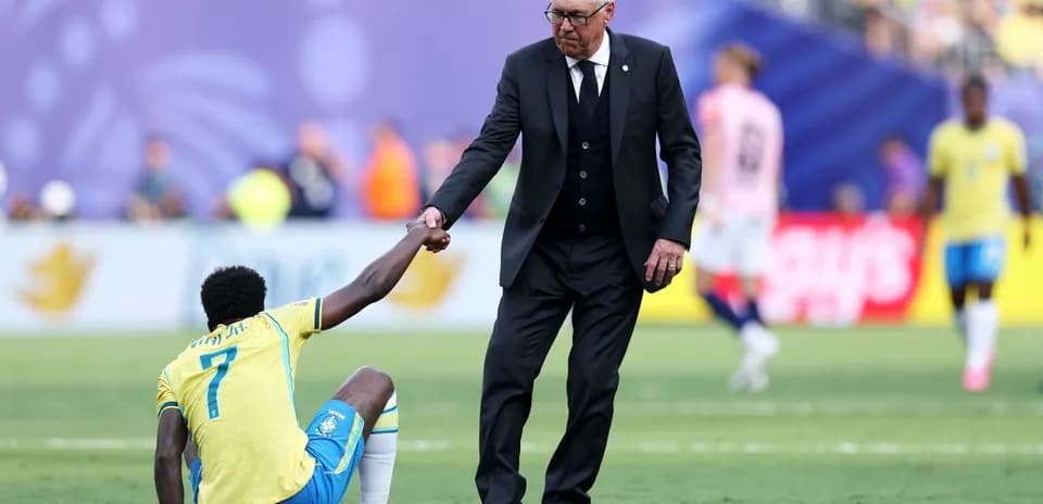 Coach helping player up from the ground