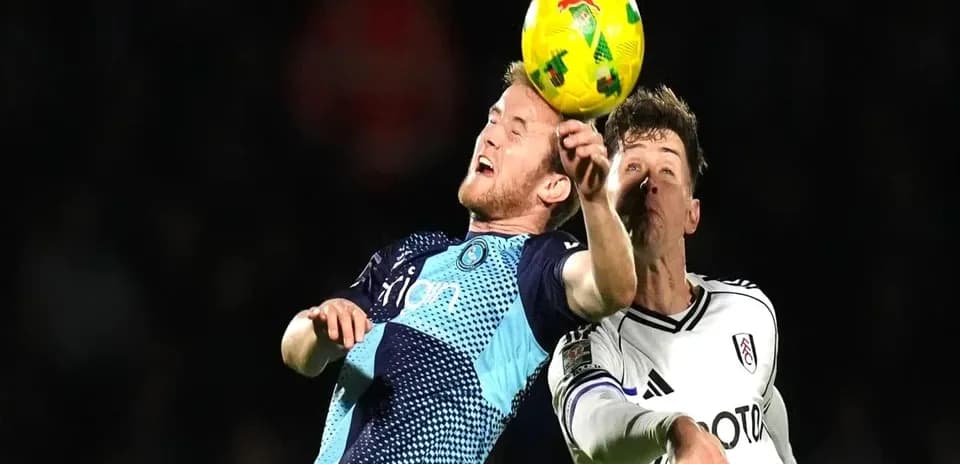 Two players contesting a header during match