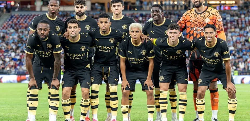 Football team posing for photo in black jerseys
