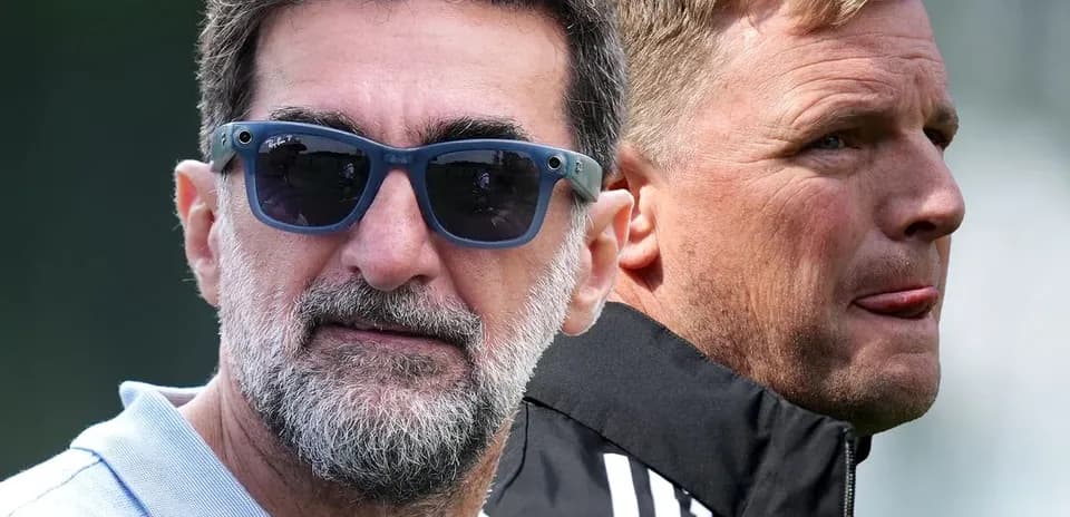 Two football coaches observing training session