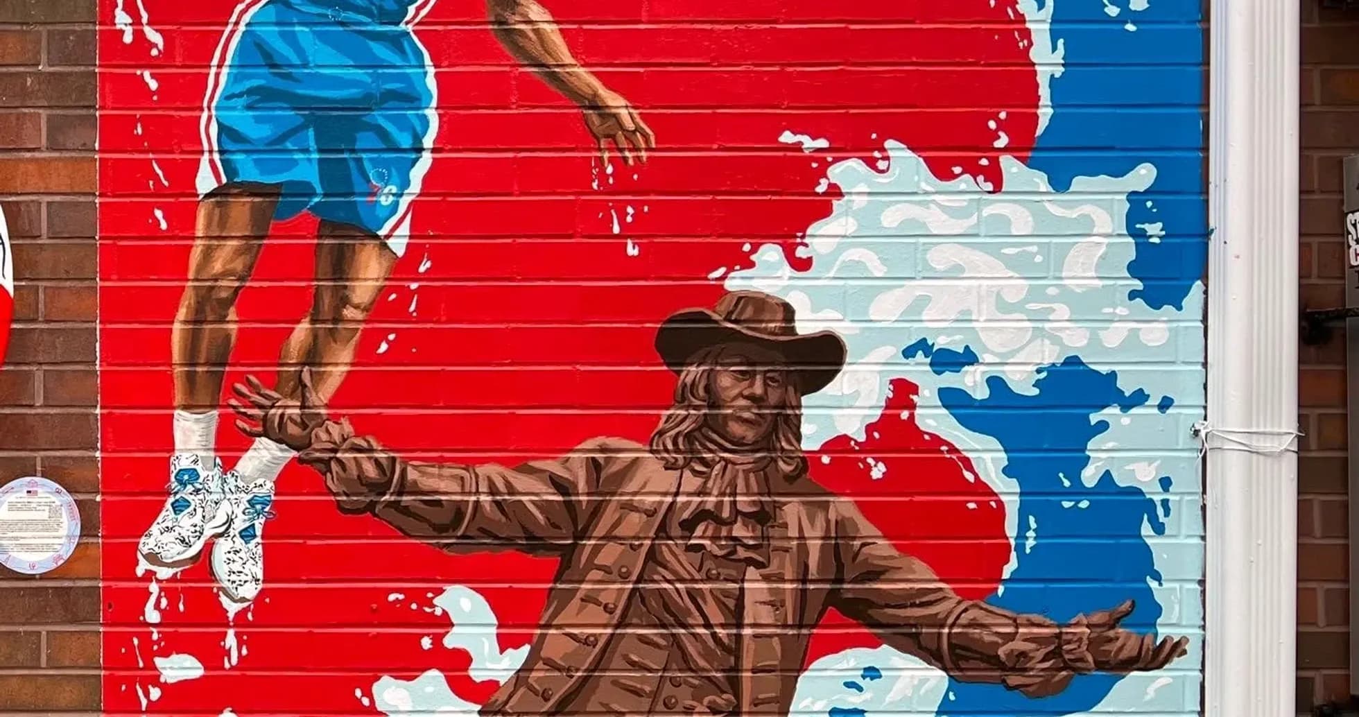 Mural of a basketball player and historical figure