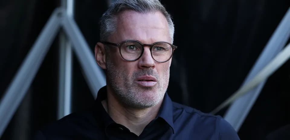 Man with glasses observing from the sidelines