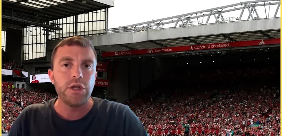 Analyst speaking in front of football stadium crowd