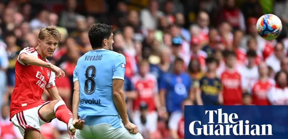 Arsenal player kicking ball towards opponent in match