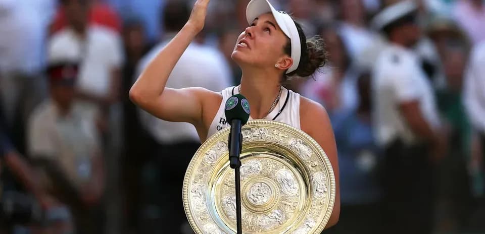 Tennis player holding Wimbledon trophy after victory