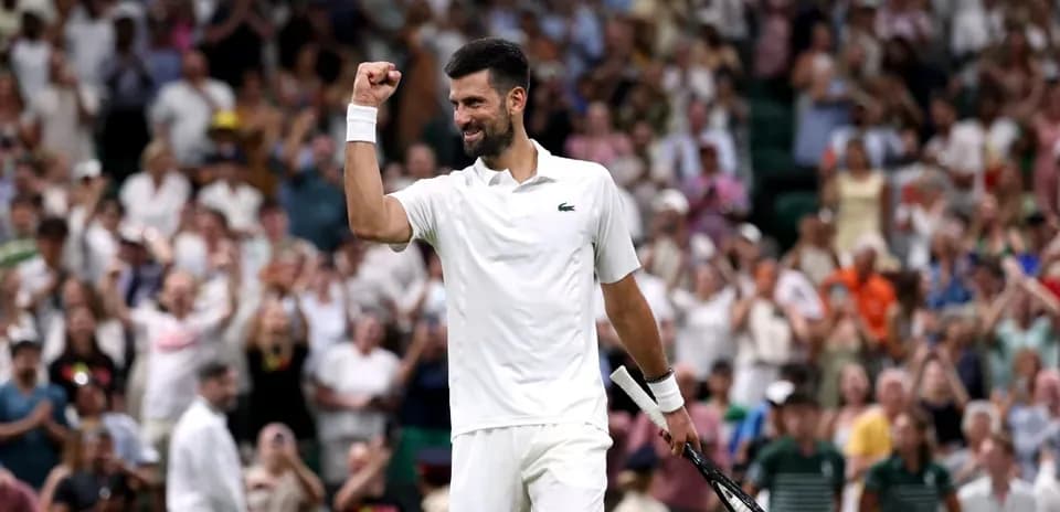Tennis player celebrating victory in front of crowd