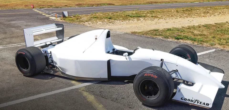 Formula car parked on an airstrip