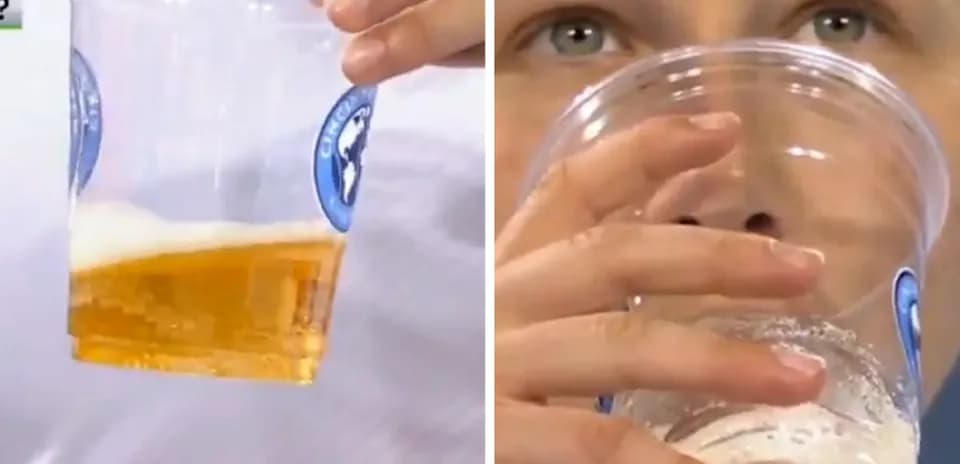 Person holding beer cup while drinking