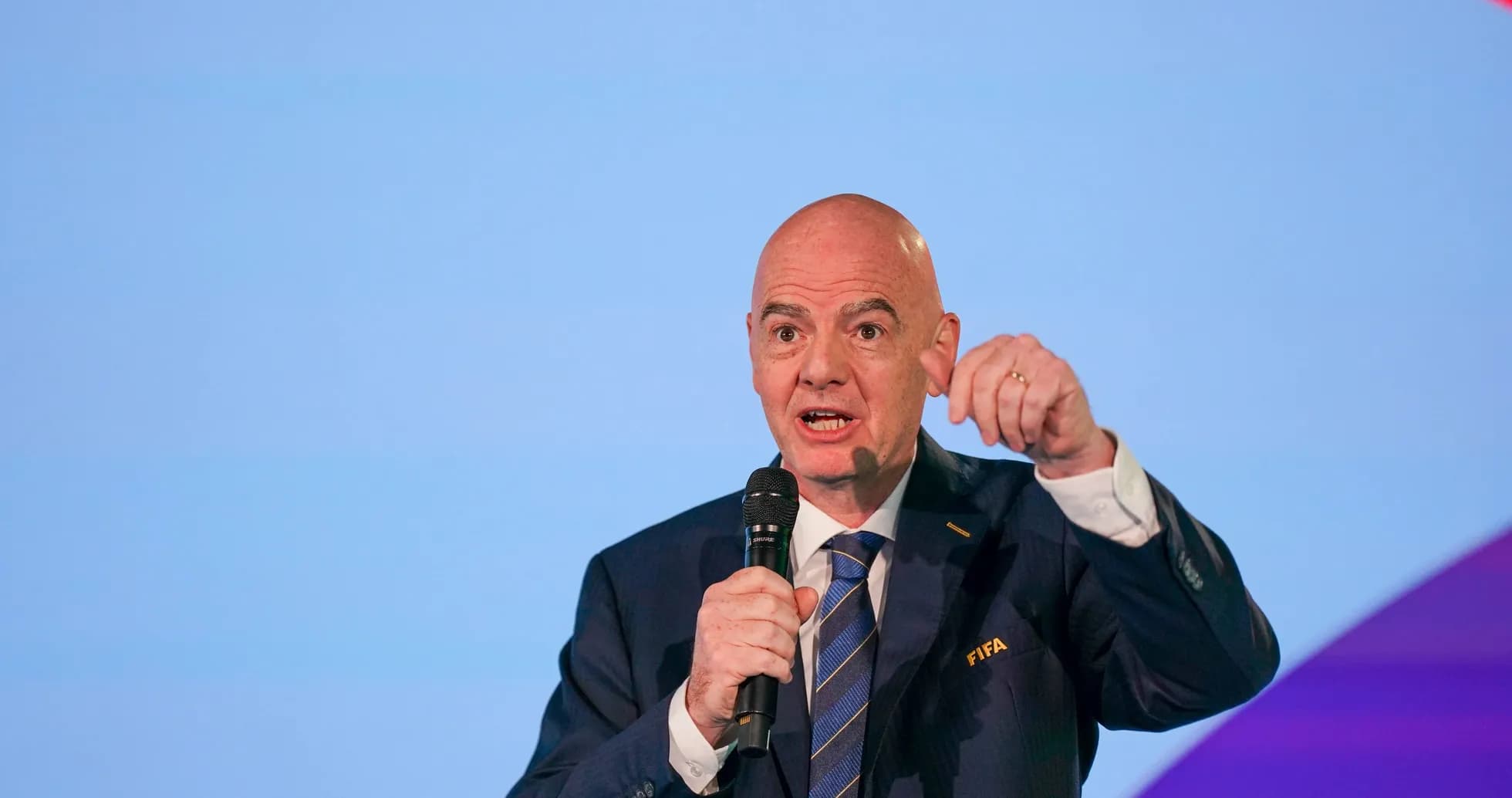 FIFA official speaking at a conference with microphone