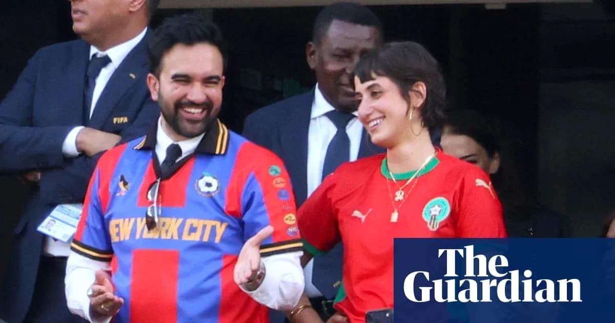 Two fans wearing team jerseys smiling together
