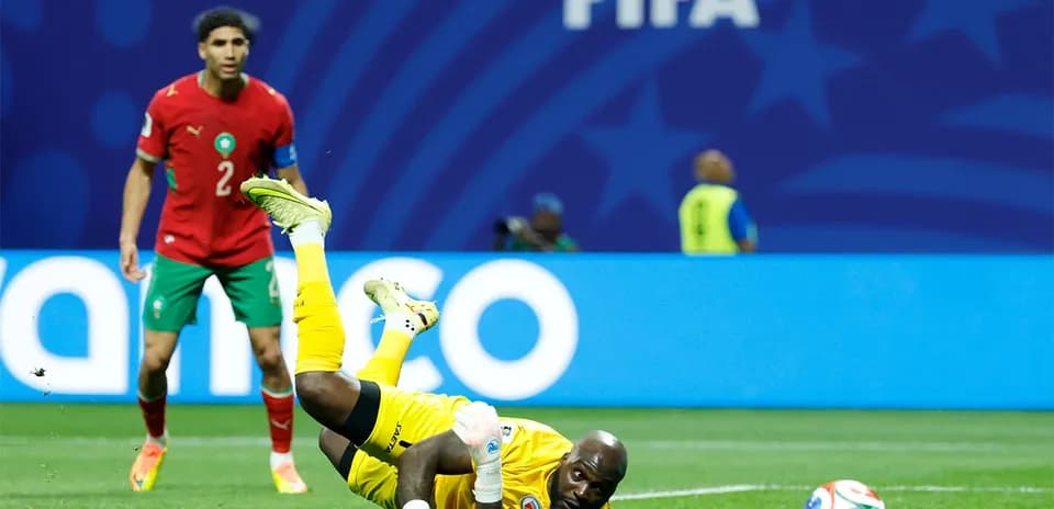 Goalkeeper diving for the ball during match