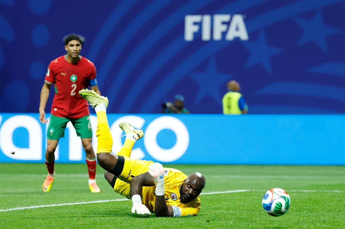Goalkeeper diving for the ball during match