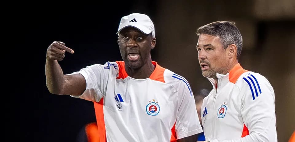 Two coaches discussing strategy during a match