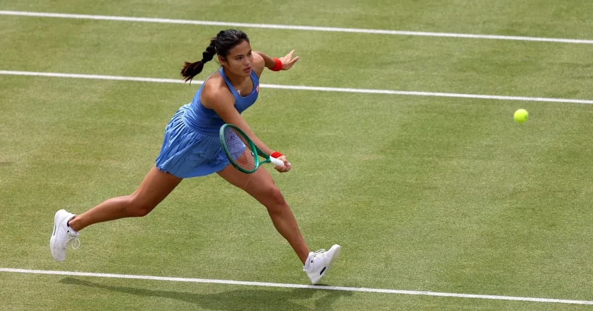 Tennis player returning a shot on grass court