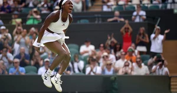Tennis player celebrating victory at Wimbledon
