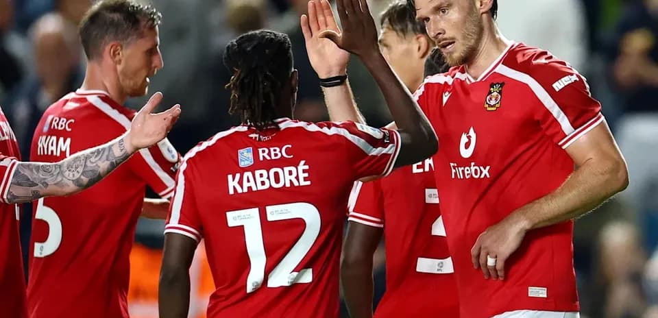 Football players celebrating a goal on the field