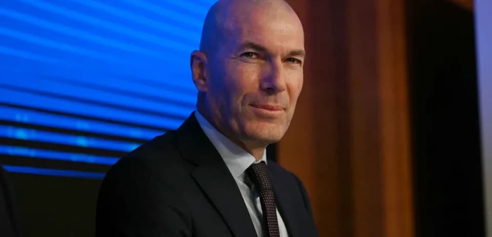 Bald man in suit at a press conference