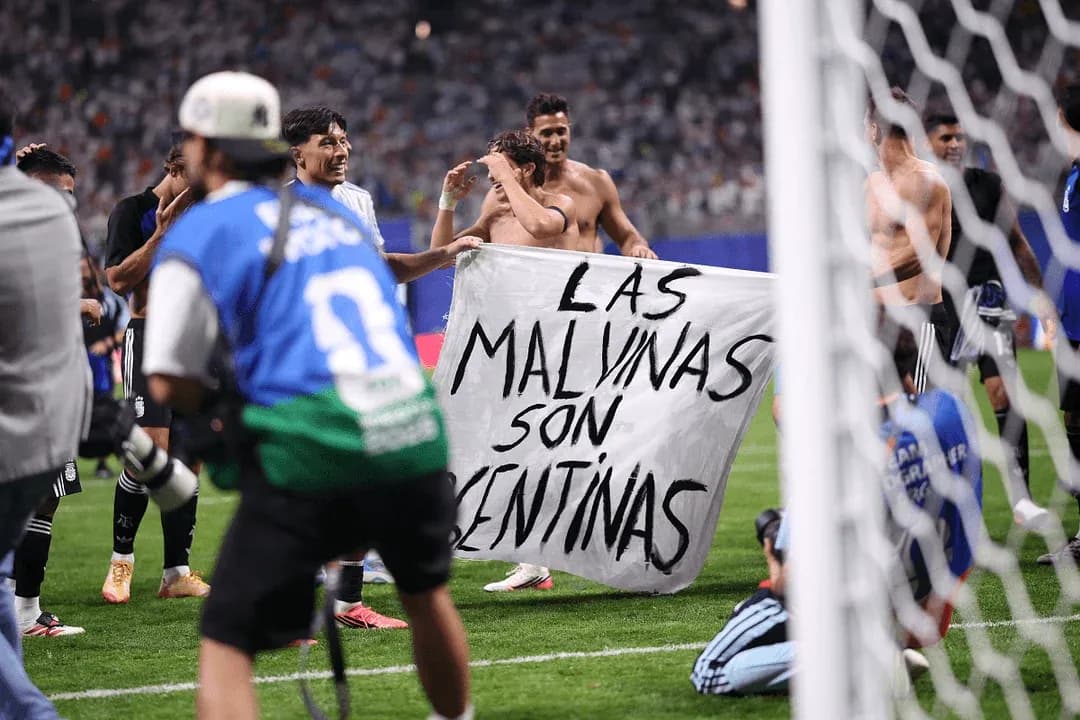 Players celebrating with a banner after match