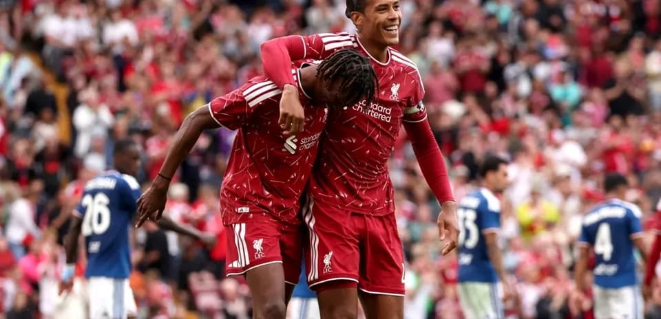 Liverpool players celebrating a goal in stadium