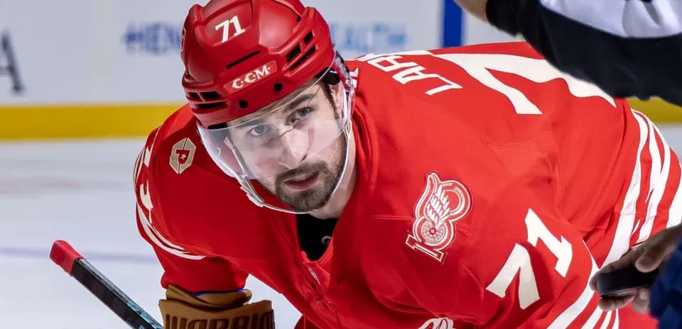 Hockey player in red jersey preparing for play