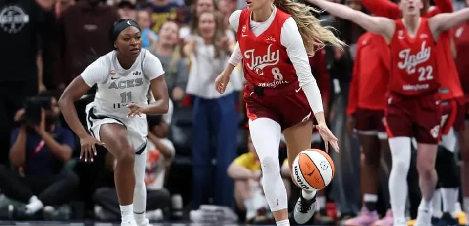 Two basketball players competing for the ball