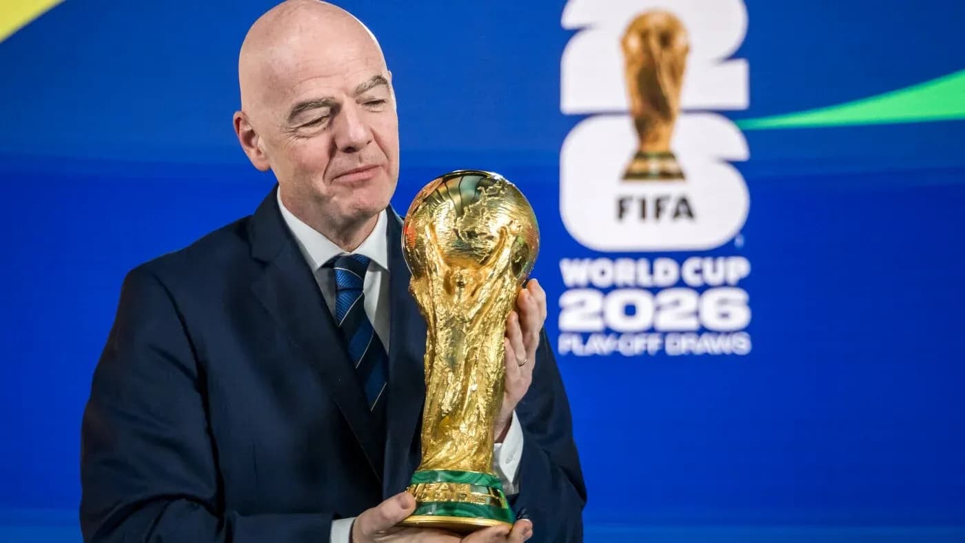 FIFA president holding World Cup trophy at event