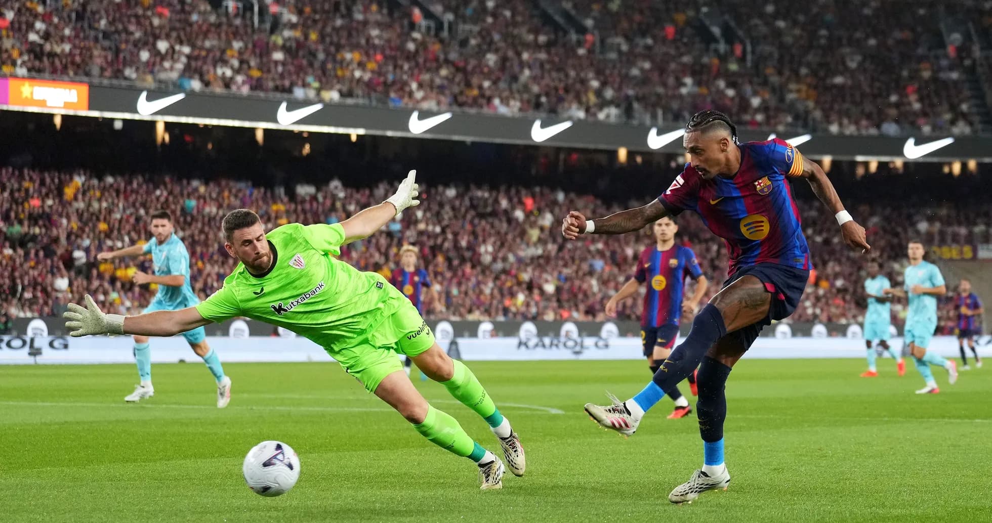 Barcelona player attempting to score against goalkeeper