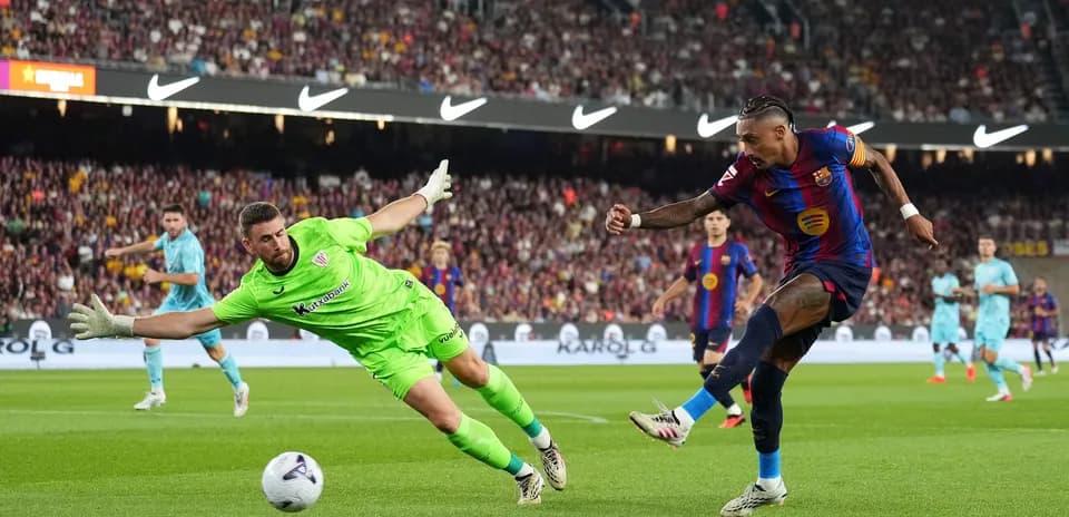Barcelona player attempting to score against goalkeeper