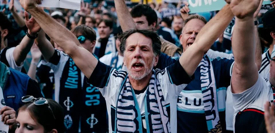 Vancouver fans cheering with banners during match